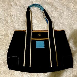 Beautiful dark blue coach bag and crème colored interior.